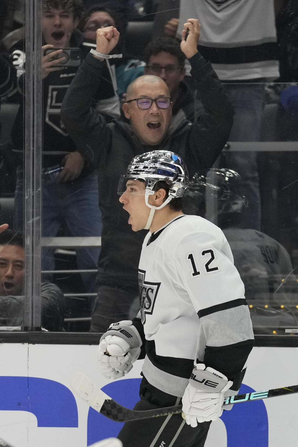 Los Angeles Kings left wing Trevor Moore (12) celebrates after scoring during the second period of an NHL hockey game against the San Jose Sharks Monday, Jan. 22, 2024, in Los Angeles. (AP Photo/Ashley Landis)