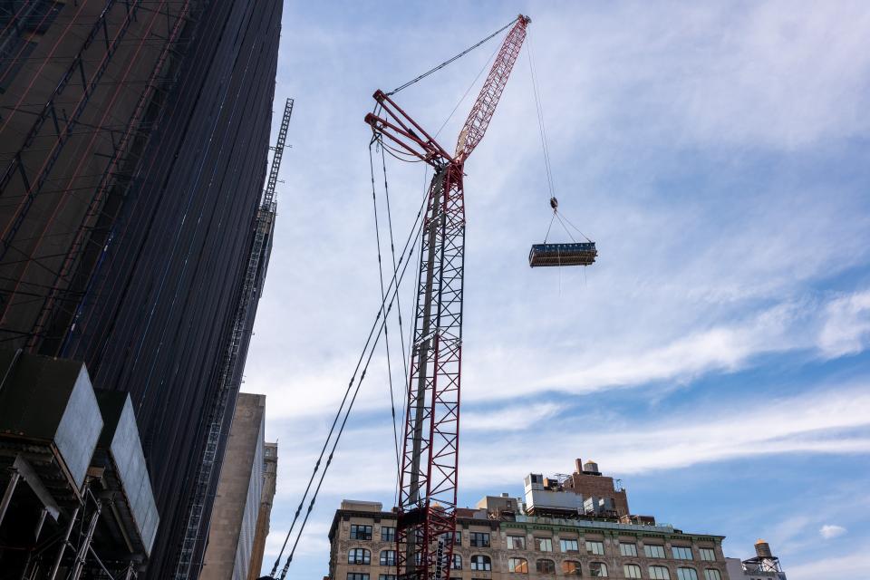 Crains operating the demolition of the Manhattan Detention Complex in Chinatown.