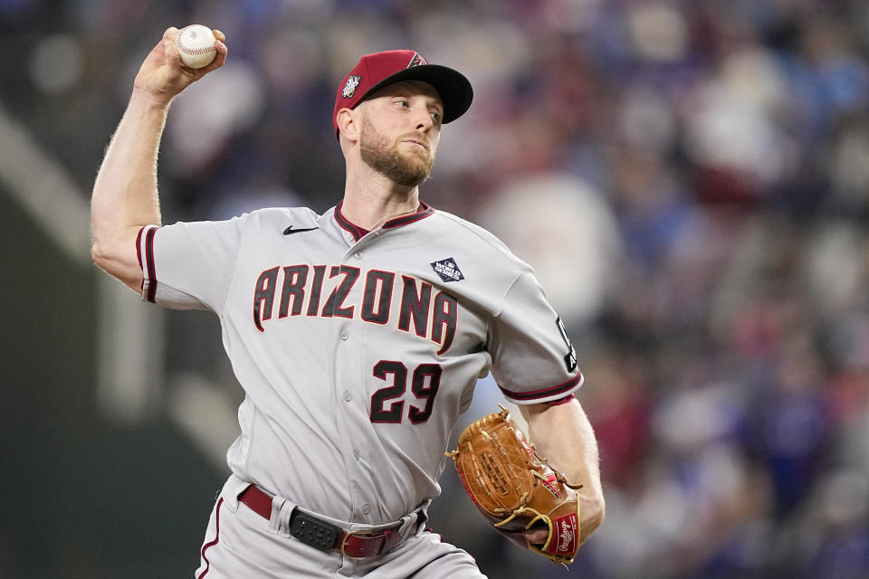 Arizona Diamondbacks starting pitcher Merrill Kelly throws against the Texas Rangers during the first inning in Game 2 of the baseball World Series Saturday, Oct. 28, 2023, in Arlington, Texas. (AP Photo/Brynn Anderson)