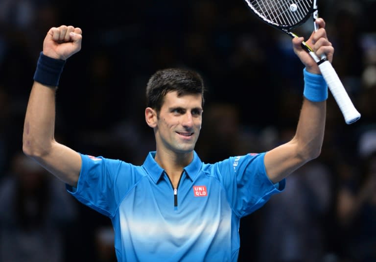 Novak Djokovic celebrates after beating Roger Federer to claim the ATP World Tour Finals title in London, on November 22, 2015