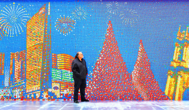 China now has two spectacular great walls. Josh Chalmon stands in front of a giant mosaic made from 85,794 Rubik's Cubes, Macau, China. The wall is 220ft long and 13ft tall and shows the skyline of Macau. Canadian Josh Chalmon had to hand twist all of the Rubik's Cubes before assembling the wall - which is now in the Guinness World Records as the 'Largest Rubik's Cube Mosaic Ever Created' (Solent News/Rex Features)