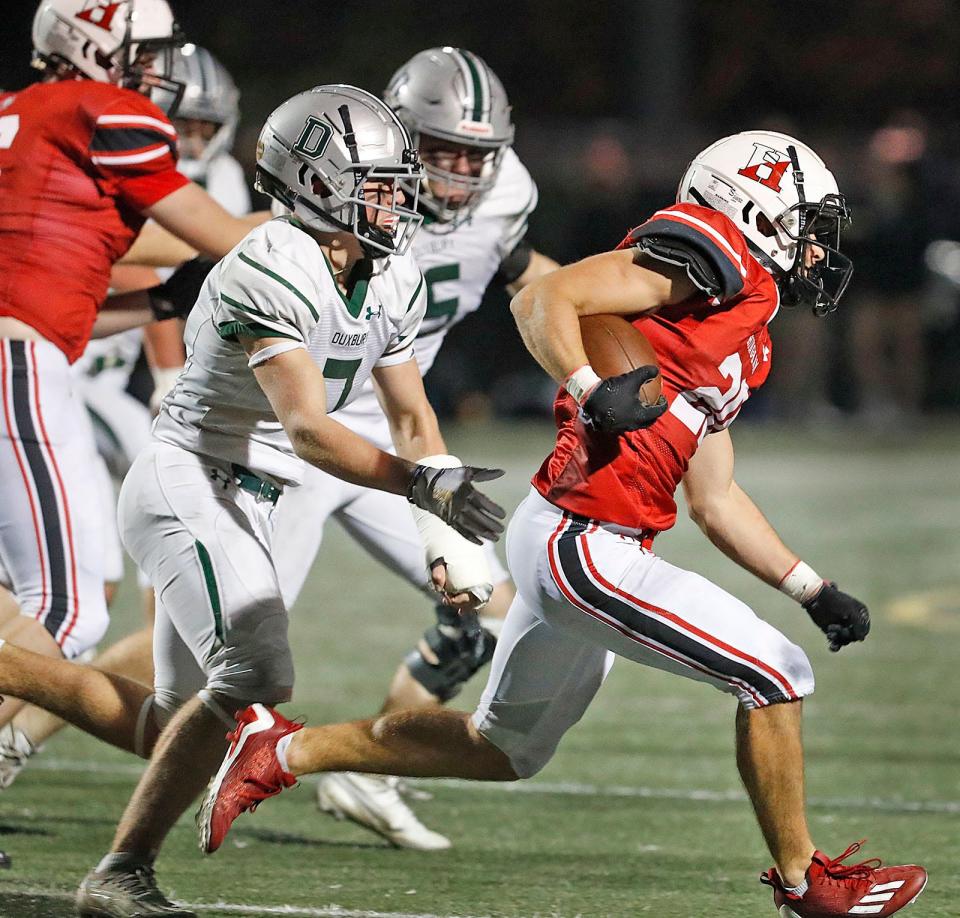 Running back Will St. Pierre is one step ahead of Dragons tackle Jack Rees.
The Hingham Harbormen hosted the Duxbury Dragons on the gridiron Friday, Oct. 27, 2023