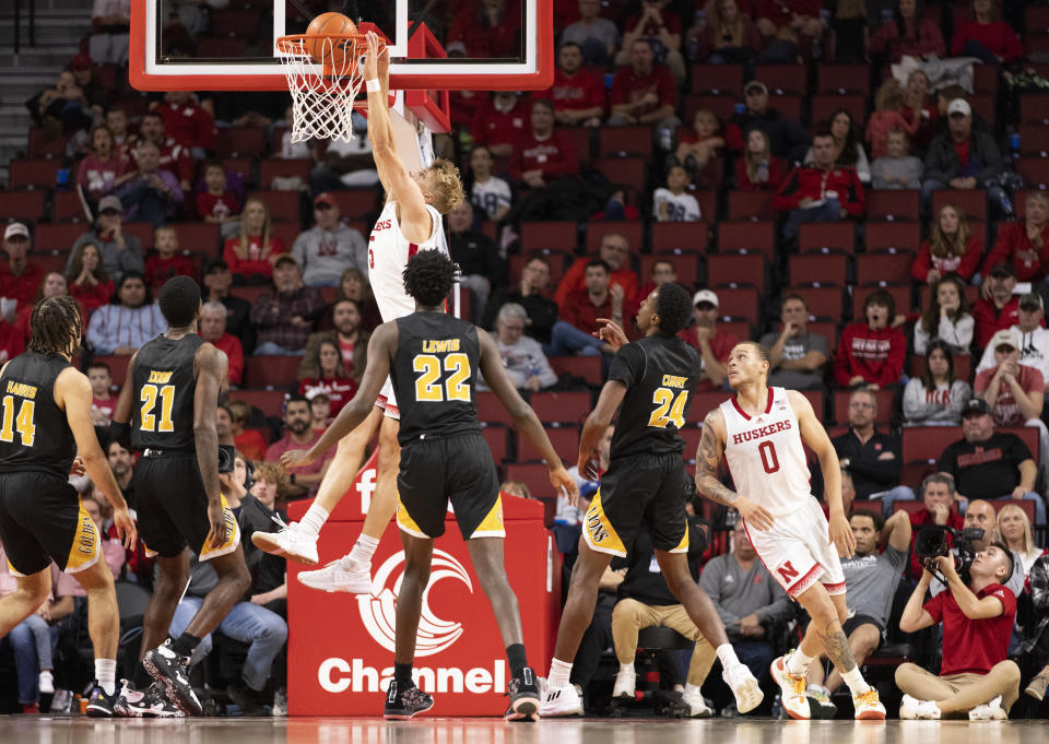 Nebraska's Sam Griesel (5) dunks over Arkansas-Pine Bluff's Brahm Harris (14), Shaun Doss Jr. (21), Robert Lewis (22) and AC Curry (24) during the second half of an NCAA college basketball game on Sunday, Nov. 20, 2022, in Lincoln, Neb. (AP Photo/Rebecca S. Gratz)