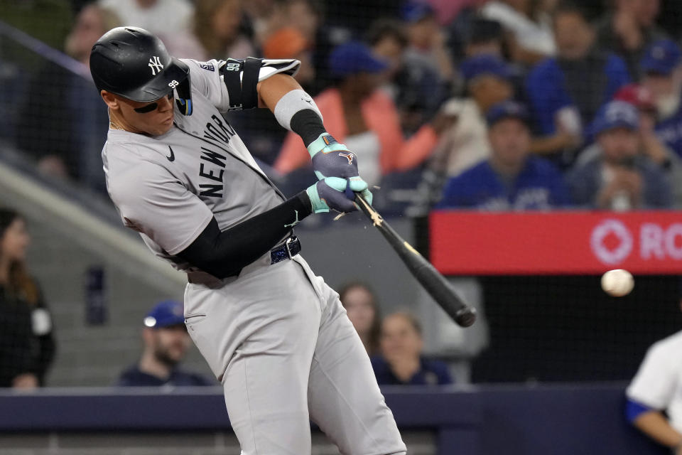 New York Yankees' Aaron Judge (99) breaks his bat on a pitch from Toronto Blue Jays' Kevin Gausman during the third inning of a baseball game in Toronto, Wednesday, April 17, 2024. (Chris Young/The Canadian Press via AP)