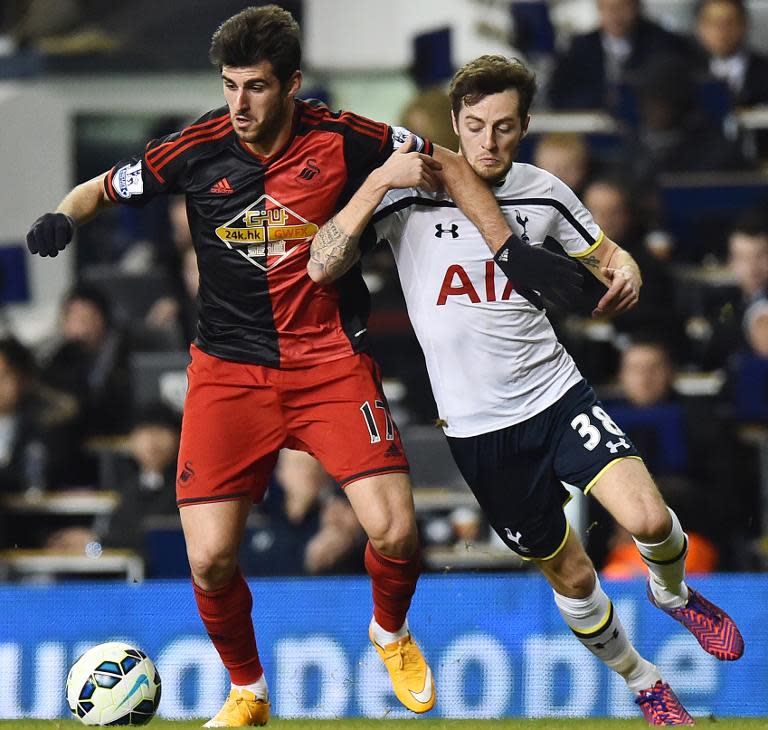 Swansea City's Portuguese striker Nelson Oliveira (L) vies for the ball with Tottenham Hotspur's English midfielder Ryan Mason during their English Premier League football match in London on March 4, 2015