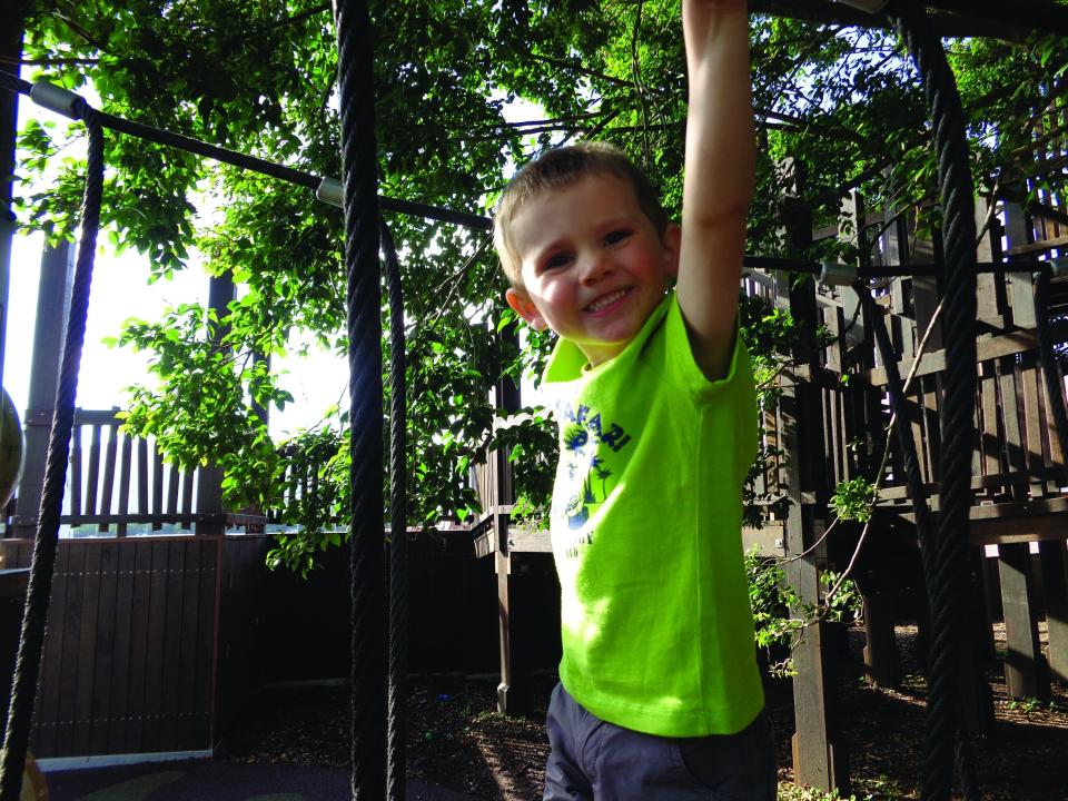 Wiliam Tyrrell pictured playing outside in a green t-shirt.