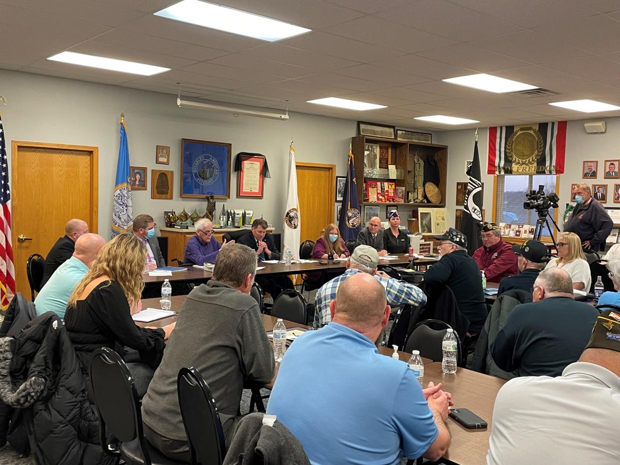 Senator Mike Rounds, center, listens to complains Sioux Falls veterans have about the Community Care program run through the VA.