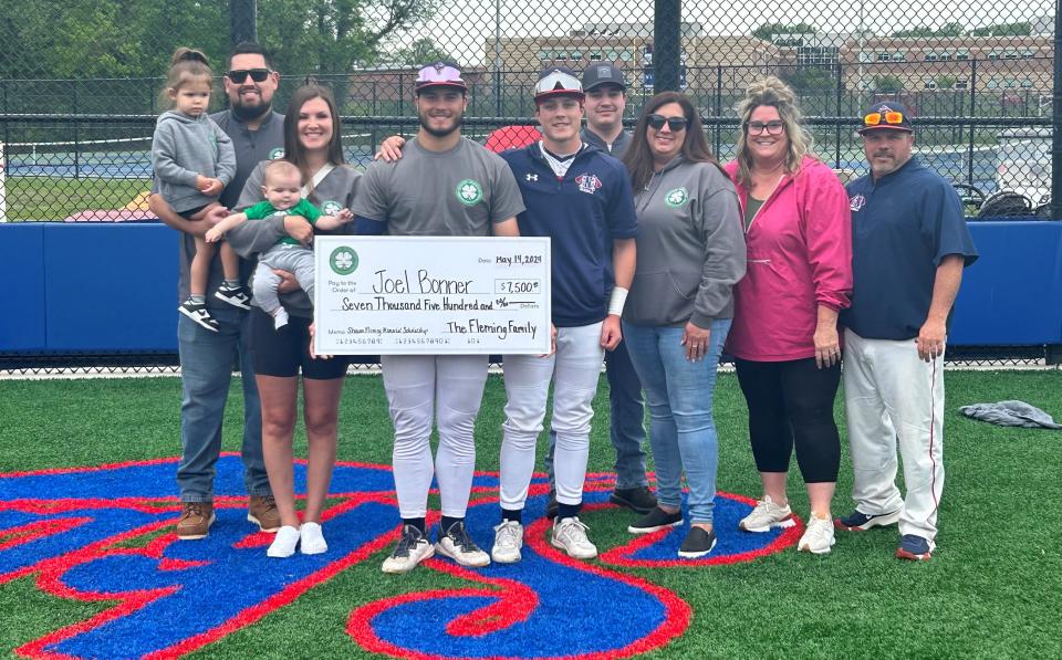 Neshaminy senior Joel Bonner (holding check), his family and Shawn Fleming's family celebrate Bonner receiving the Shawn Fleming Memorial Scholarship.