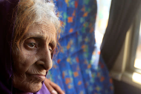 An elderly woman sits in a vehicle to be transported to a camp for displaced people during the battle between Iraqi forces and Islamic State militants in western of Mosul, Iraq, May 17, 2017. REUTERS/ Alaa Al-Marjani