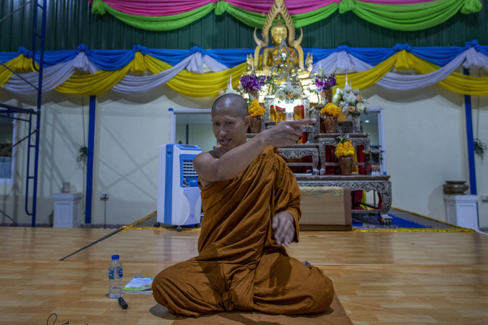 In this Monday, Feb. 10, 2020 photo, Buddhist monk Phra Manaswin gestures as he explains a shooting rampage he witnessed at Wat Pa Sattharuam Buddhist temple in Nakhon Ratchasima, Thailand. The secluded temple complex in the northeastern Thai province had opened its gates for Buddha Day, allowing in dozens of devotees, when a rogue soldier from the neighboring Army base roared through in a stolen Humvee, fatally shooting nine people, including a 13-year-old boy, and injuring more. (AP Photo/Gemunu Amarasinghe)