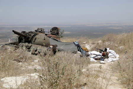 A rebel fighter from the Ahrar al-Sham Islamic Movement takes position on a hill in Jabal al-Arbaeen, which overlooks the northern town of Ariha, one of the last government strongholds in the Idlib province May 26, 2015. REUTERS/Khalil Ashawi