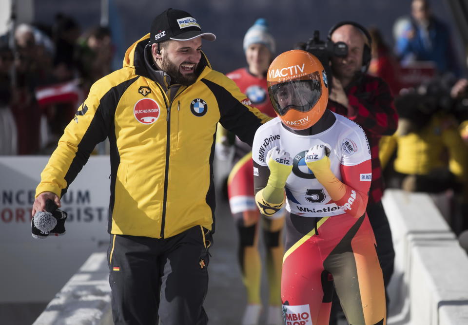 Germany's Tina Hermann, right, celebrates after winning he women's event at the Skeleton World Championships in Whistler, British Columbia, Friday, March 8, 2019. (Darryl Dyck/The Canadian Press via AP)