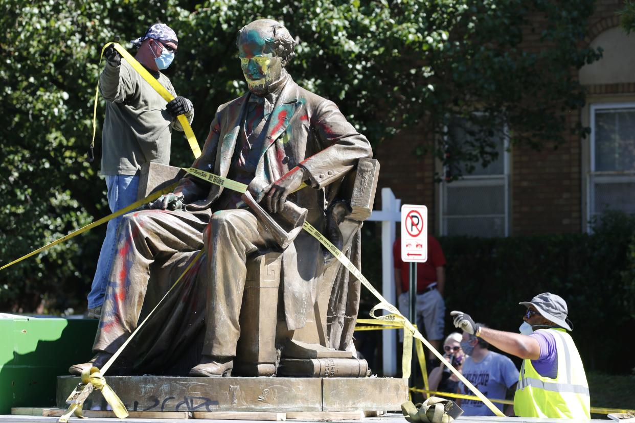 Workers secure the statue of Confederate Naval officer Matthew Fontaine Maury to a truck on Monument Avenue on Thursday, July 2, 2020, in Richmond, Va. Maury was better known for his work in oceanography and other sciences before the Civil War. His statue is the second removed since a new state law was enacted on July first.