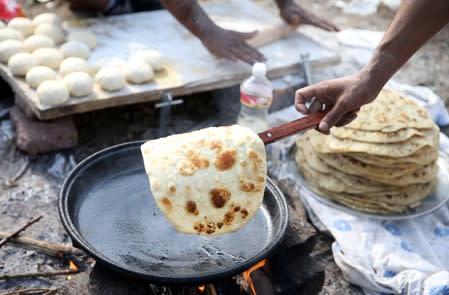 Migrants make breakfast in camp Vucjak in Bihac