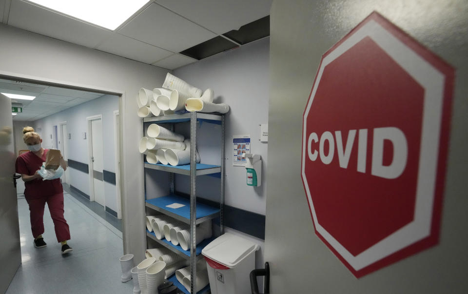 A medical staff walks near a COVID-19 ward at the hospital of the Ministry of Interior and Administration in Warsaw, Poland, on Wednesday, Jan. 19, 2022. Poland’s doctors and medics are expecting huge strain on the health care system from the rising 5th wave of COVID-19 infections. More than 30,000 new cases in 24 hours were reported Wednesday and health authorities are expecting the figure to almost double next week. (AP Photo/Czarek Sokolowski)