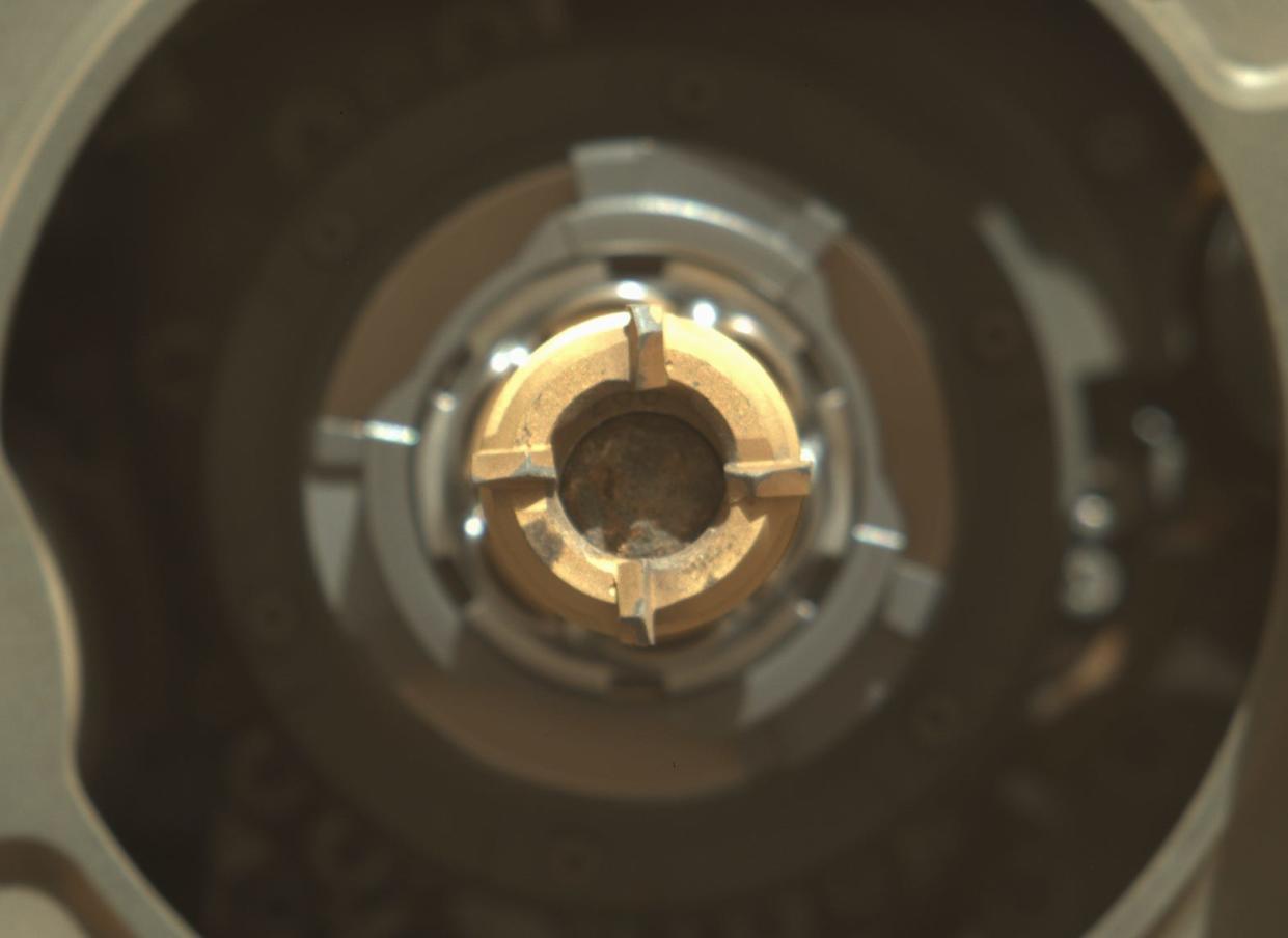 perseverance rover gold sample tube with grey rock inside