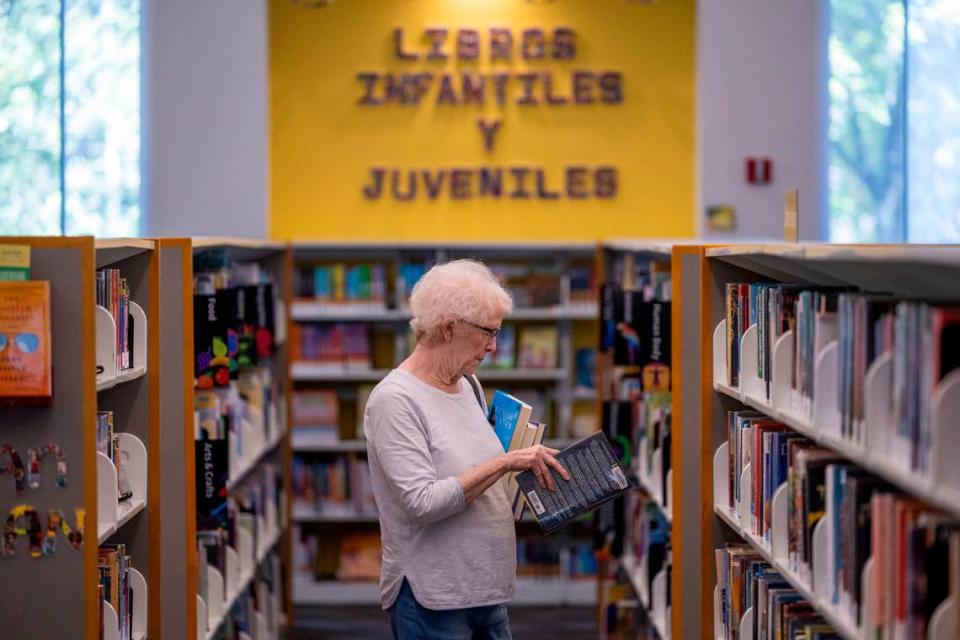 Jeri Lewis looks for books to check out at the Green Road Library in Raleigh on Tuesday, May 22, 2024.