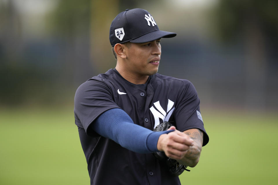 New York Yankees relief pitcher Jonathan Loaisiga stretches during a baseball spring training workout Thursday, Feb. 15, 2024, in Tampa, Fla. (AP Photo/Charlie Neibergall)