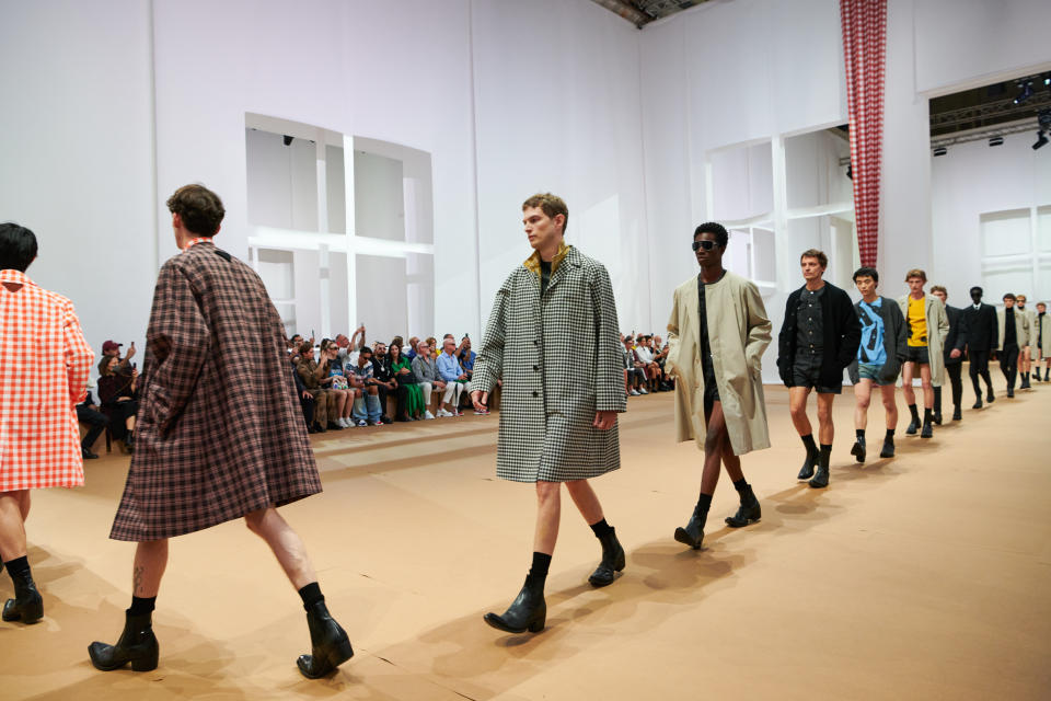 Prada spring summer ’23 men’s collection at Milan Men’s Fashion Week, with an emphasis on the black leather Cuban heeled boot with a Western shape. - Credit: Courtesy of Prada