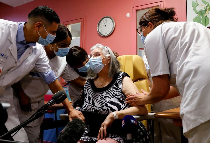 Mauricette, a 78-year-old French woman, receives the first dose of the Pfizer-BioNTech COVID-19 vaccine in the country, in Sevran