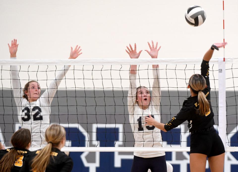 Fairless' Jayleigh Price and Cheyenne Kegley meet Black River's Delaney Nixon at the net during the first set of Wednesday's Division III girls volleyball sectional semifinal.