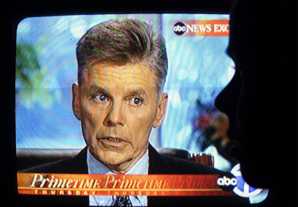 A TV screen shows a news interview with a man with short hair on ABC News. The man is speaking seriously. "Primetime Thursday" is displayed on the screen