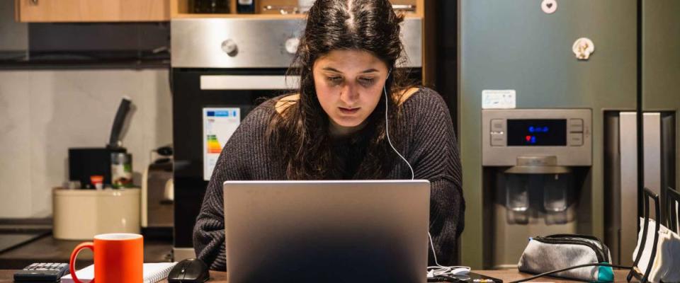 Young spanish girl teleworking at home because of the restrictions given by spanish government due to coronavirus COVID-19 sanitary crysis