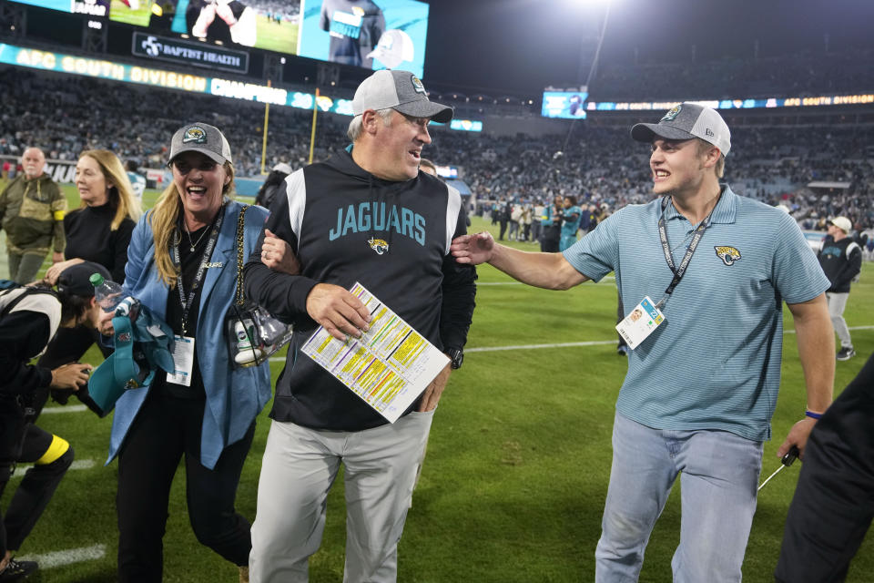 Jacksonville Jaguars head coach Doug Pederson walks off the field with his wife Jeannie, left, and son Joel, right, after defeating the Tennessee Titans in an NFL football game, Saturday, Jan. 7, 2023, in Jacksonville, Fla. The Jaguars won 20-16. (AP Photo/John Raoux)