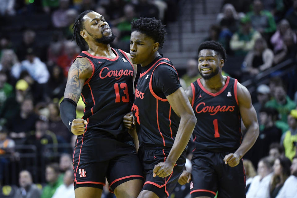 Houston guard Terrance Arceneaux (23) celebrates his 3-point shot against Oregon with forward J'Wan Roberts (13) and Houston guard Jamal Shead (1) during the first half of an NCAA college basketball game Sunday, Nov. 20, 2022, in Eugene, Ore. (AP Photo/Andy Nelson)