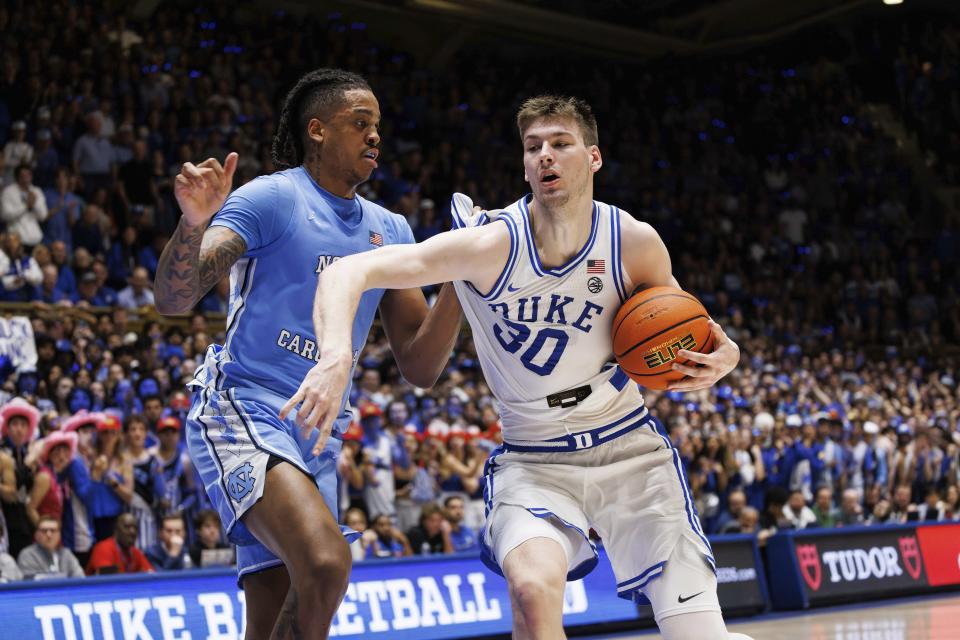 Duke's Kyle Filipowski (30) drives against North Carolina's Armando Bacot during the second half of an NCAA college basketball game in Durham, N.C., Saturday, March 9, 2024. (AP Photo/Ben McKeown)