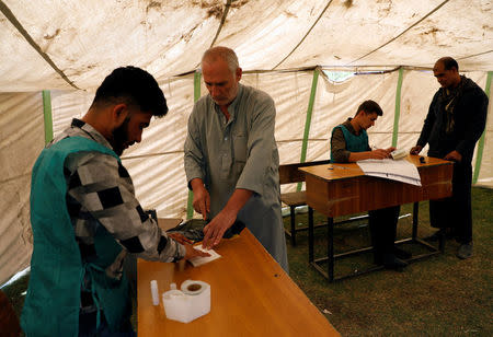 Afghan men arrive at a voter registration centre to register for the upcoming parliamentary and district council elections in Kabul, Afghanistan April 23, 2018. REUTERS/Mohammad Ismail