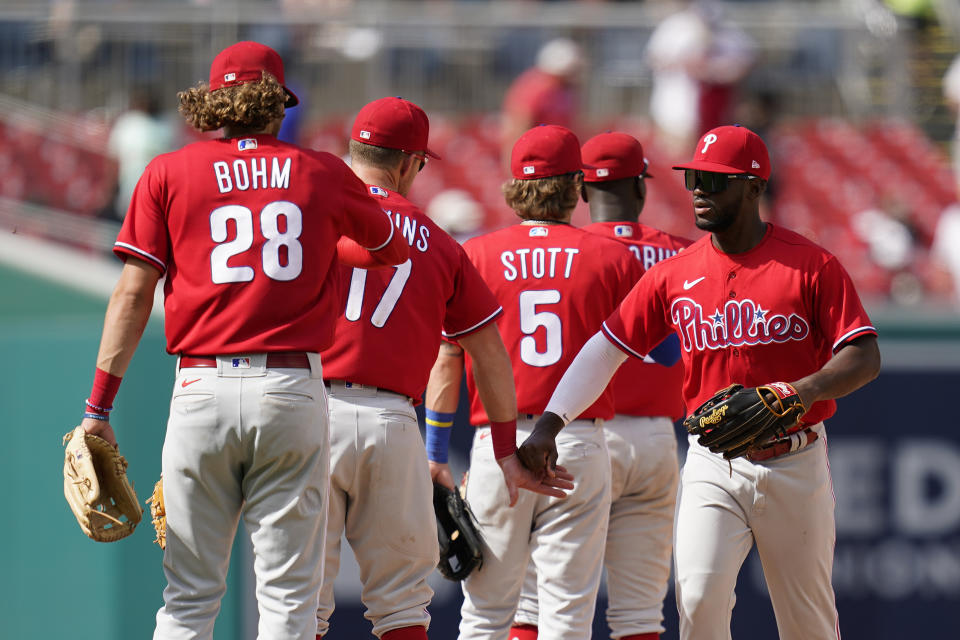 Philadelphia Phillies center fielder Odubel Herrera, right, celebrates with teammates after winning the first game of a baseball doubleheader against the Washington Nationals, Friday, June 17, 2022, in Washington. Philadelphia won 5-3. (AP Photo/Patrick Semansky)