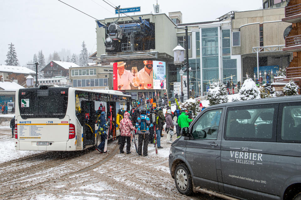 VERBIER, SWITZERLAND - DECEMBER 29: Skiers exit the bus to enter the queue for cabin transport on December 29, 2020 in Verbier, Switzerland. Most British tourists are said to have left the ski resorts after Covid-19 quarantine restrictions were introduced by the Swiss government on December 21 due to a new variant of the coronavirus found in the UK. (Photo by Robert Hradil/Getty Images)