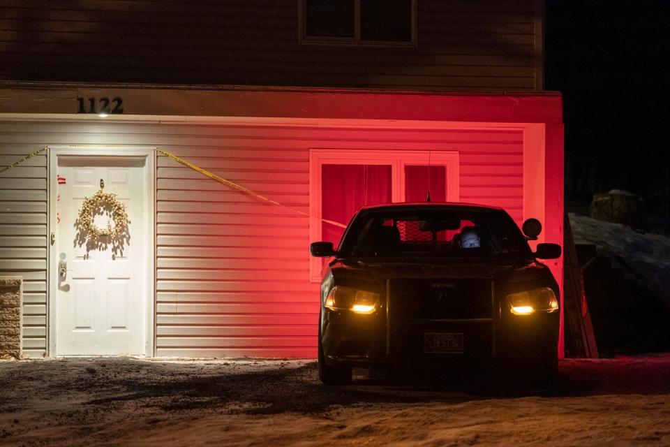 A private security guard outside the home where four University of Idaho students were killed on 13 November (Associated Press)