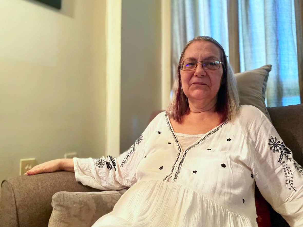 Margaret Bristow sits on her couch in her Ottawa apartment. She didn't get approved for medical assistance in dying in Ottawa after several years and attempts. She will get her procedure on Aug. 10, at a hospital in Brampton, Ont., instead. (Priscilla Ki Sun Hwang/CBC - image credit)