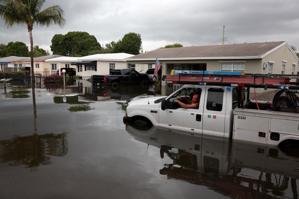 A person sits in a stalled truck along a flooded street in Fort Lauderdale, Fla., on April 13, 2023.<span class="copyright">Joe Raedle—Getty Images</span>