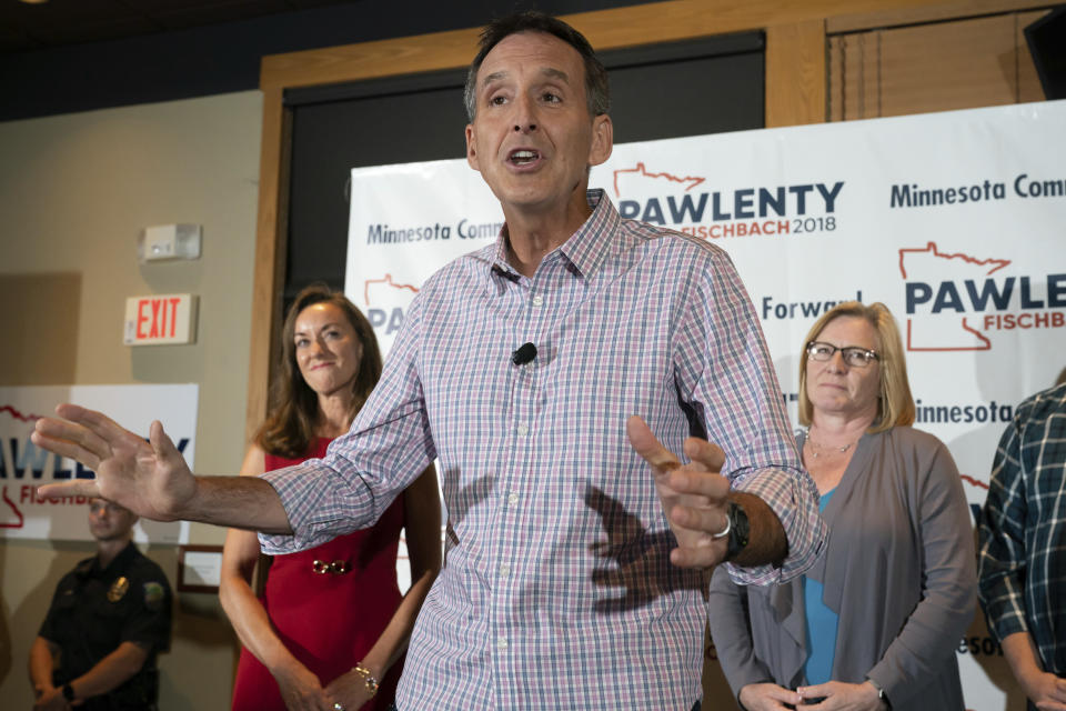 Tim Pawlenty stands with his wife, Mary, background left, and running mate Michelle Fischbach as he concedes his run for governor at his election night gathering at Granite City Food and Brewery, Tuesday, Aug. 14, 2018, in Eagan, Minn. (Glen Stubbe/Star Tribune via AP)