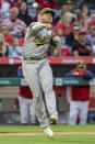 Oakland Athletics third baseman Sheldon Neuse throws to first get out Los Angeles Angels' Andrew Velazquez on a bunt-attempt during the first inning of a baseball game in Anaheim, Calif., Friday, May 20, 2022. (AP Photo/Alex Gallardo)