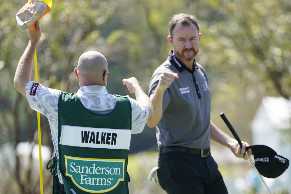 Jimmy Walker, right, fist bumps with his caddie following the first round of the Sanderson Farms Championship golf tournament in Jackson, Miss., Thursday, Oct. 1, 2020. (AP Photo/Rogelio V. Solis)