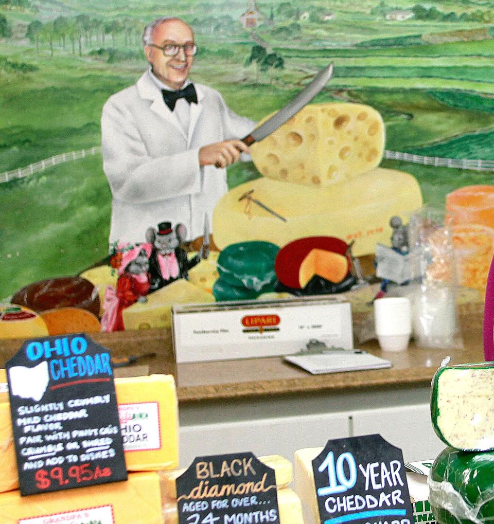 Dick Baum, aka Grandpa, is seen in the mural behind the cheese counter Grandpa's Cheese Barn.