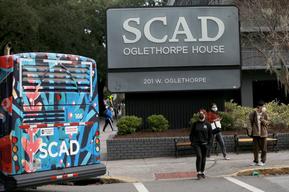 Savannah College of Art and Design Students wait for a bus outside Oglethorpe House.