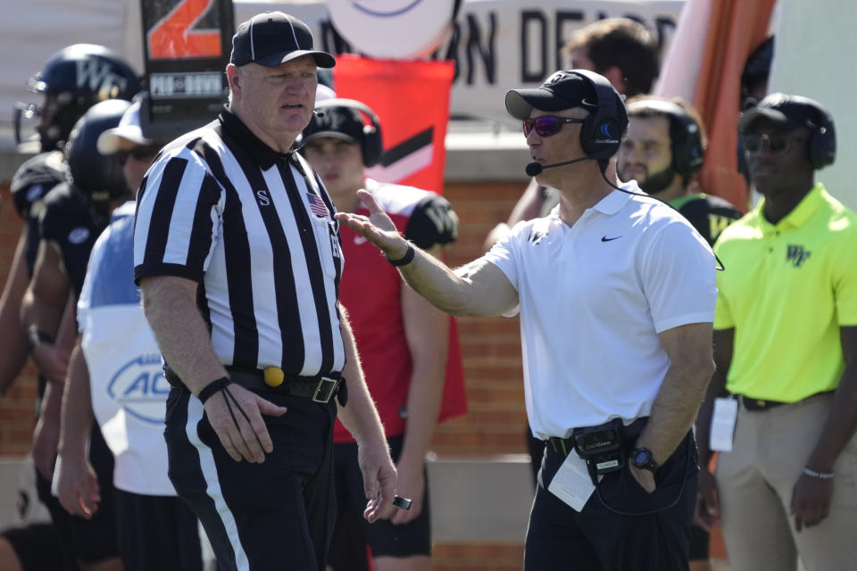 Wake Forest head coach Dave Clawson, right, argues a call during the first half of an NCAA college football game against Florida State in Winston-Salem, N.C., Saturday, Oct. 28, 2023. (AP Photo/Chuck Burton)