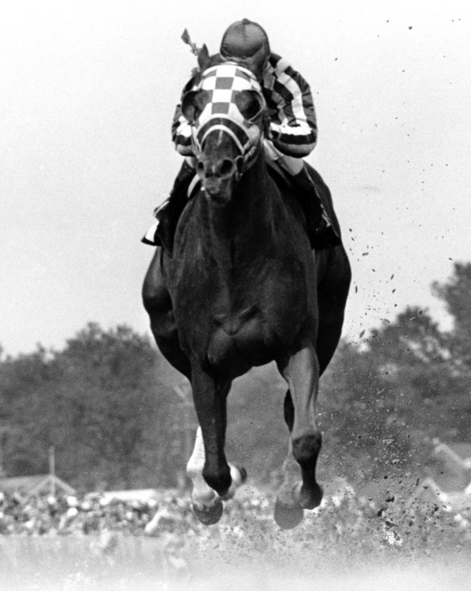 FILE - In this May 5, 1973, file photo, jockey Ron Turcotte rides Secretariat to victory in the Kentucky Derby horse race at Churchill Downs in Louisville, Ky. Secretariat is the early 7-2 favorite for this weekend’s virtual Kentucky Derby, an animated race pitting all 13 Triple Crown winners on the day the Derby would have been held before the coronavirus pandemic postponed it.(AP Photo/File)