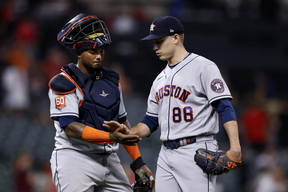 Houston Astros catcher Martin Maldonado, left, and relief pitcher Phil Maton celebrate the team's 6-0 win over the Cleveland Guardians in a baseball game Thursday, Aug. 4, 2022, in Cleveland. (AP Photo/Ron Schwane)