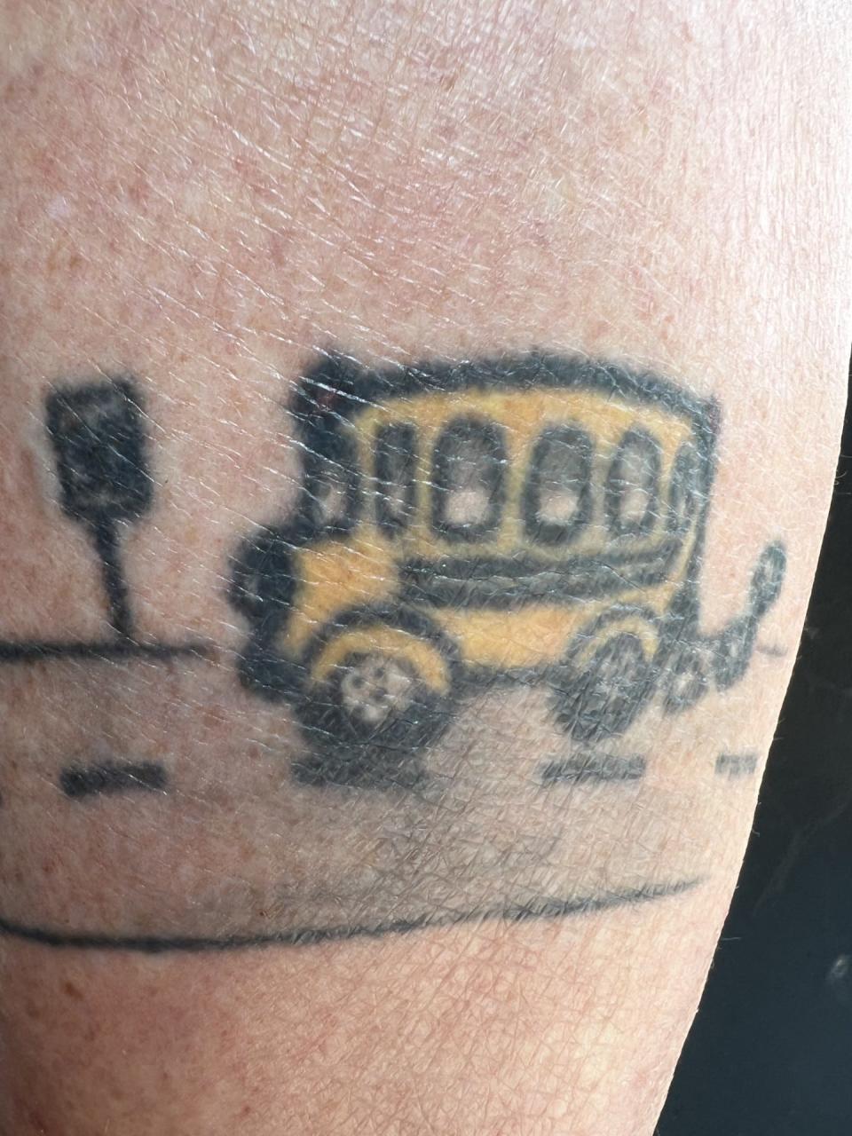 One part of Sherry Mytko's tattoo shows a small yellow bus nearing a 25-mph speed limit sign.