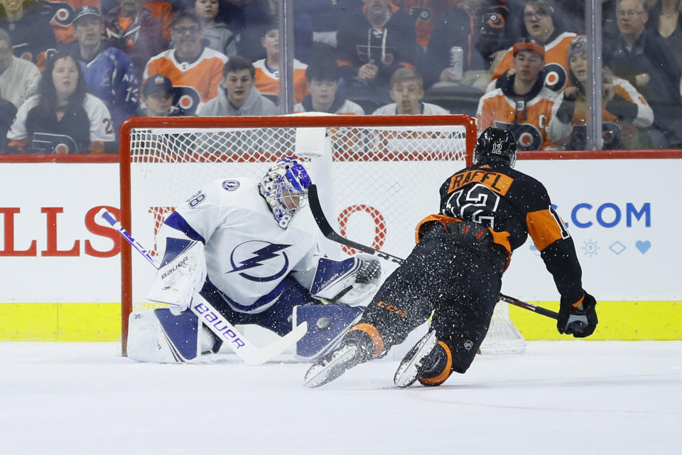 Tampa Bay Lightning's Andrei Vasilevskiy, left, blocks a shot by Philadelphia Flyers' Michael Raffl during the first period of an NHL hockey game, Saturday, Jan. 11, 2020, in Philadelphia. (AP Photo/Matt Slocum)