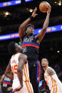 Detroit Pistons center James Wiseman, center, shoots over Atlanta Hawks center Clint Capela, left, during the second half of an NBA basketball game Tuesday, March 21, 2023, in Atlanta. (AP Photo/Alex Slitz)