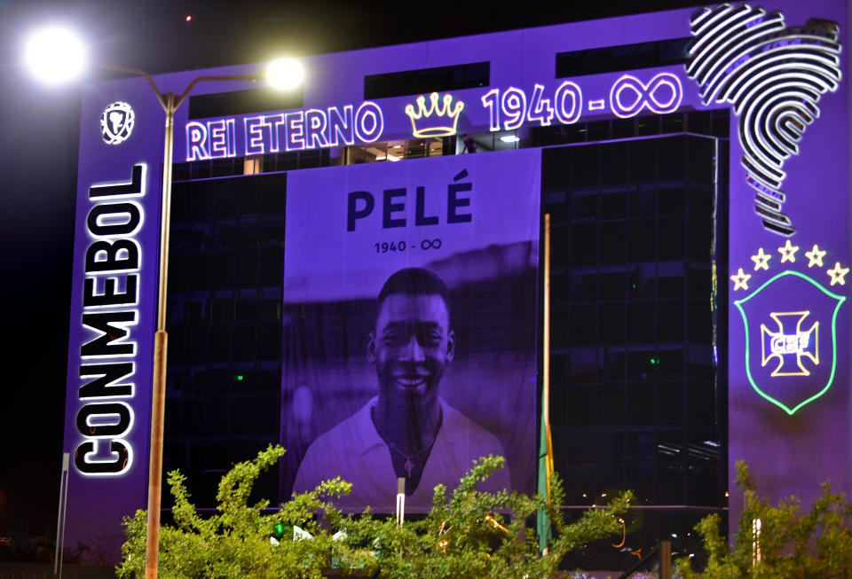 An image of Brazilian football legend Edson Arantes do Nascimento, known as Pele, whose death was announced earlier in the day, is displayed on the facade of the headquarters of Conmebol, the South American Football Confederation, in Luque, Paraguay, on December 29, 2022.