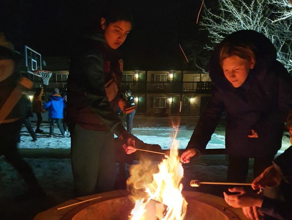 Students from Barr Beacon school toast marshmallows on a fire