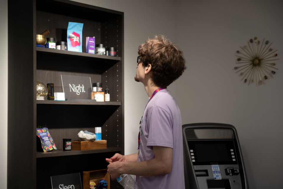 Ben Bowman, an employee of Bliss Ohio in Kent, checks on display focused on sleep products.